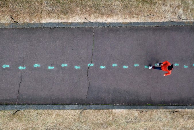 image showing person walking in pre-painted footprints